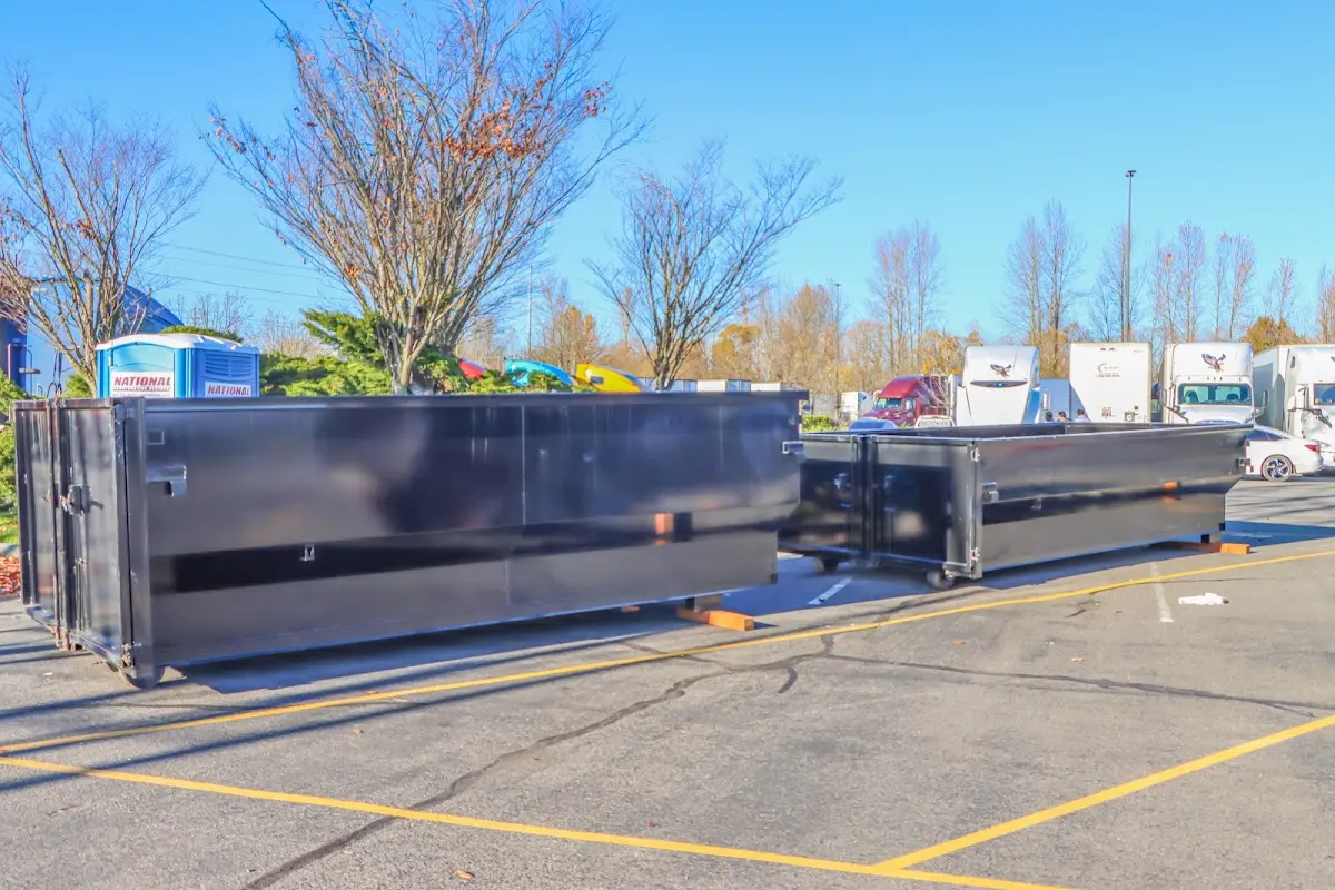 Professional dumpster rental service with roll-off container on residential driveway in Donna